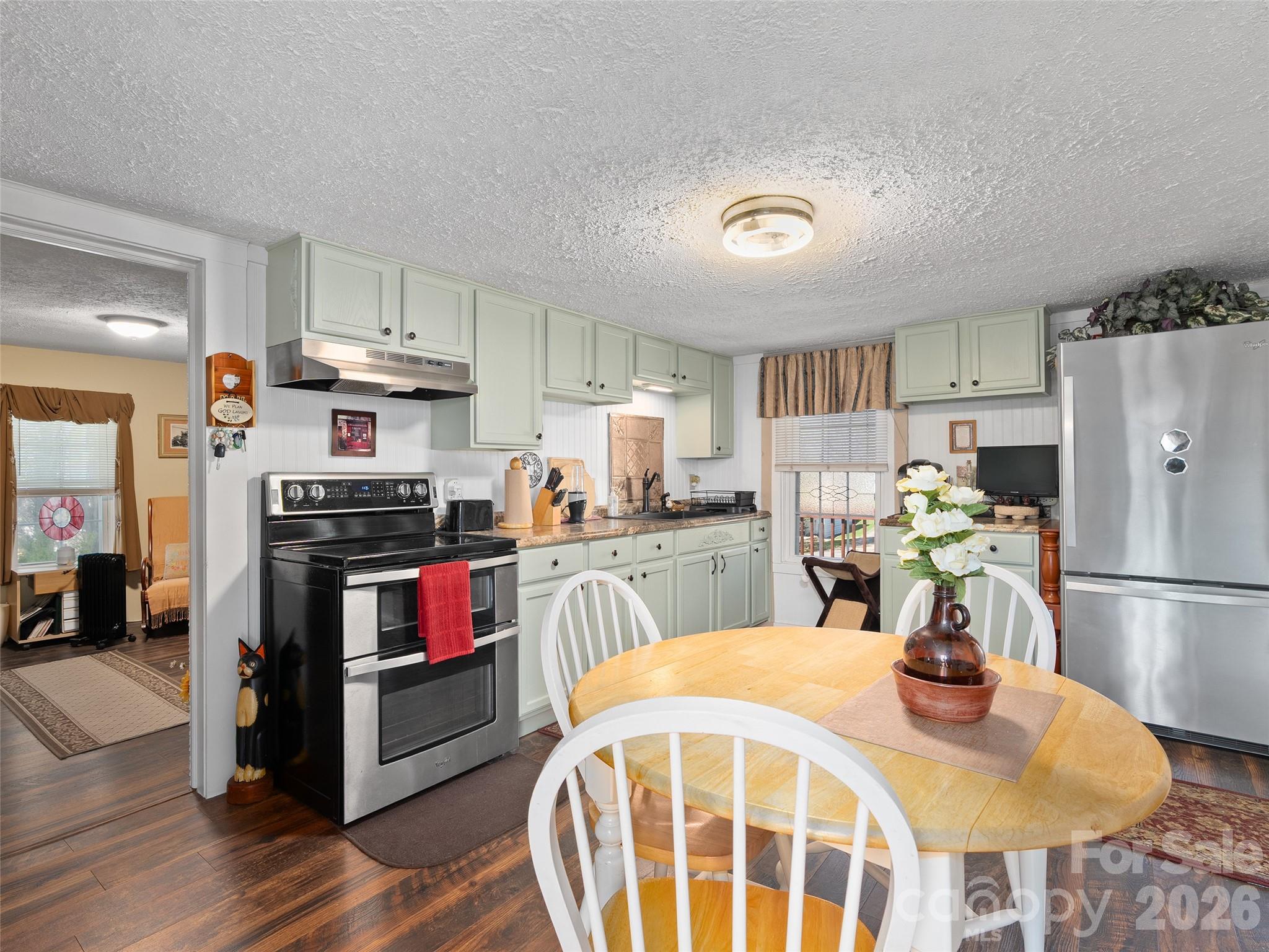 19 Mingus Street Canton, NC 28716 - Photo 13 of 28 a kitchen with a refrigerator and a stove top oven