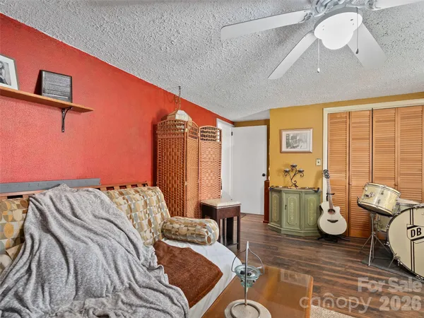 a bed room with a bed and a chair