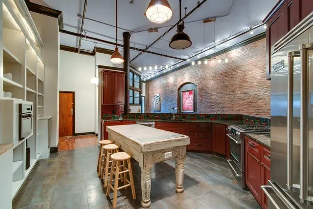 a view of a kitchen with stainless steel appliances granite countertop lots of counter top space