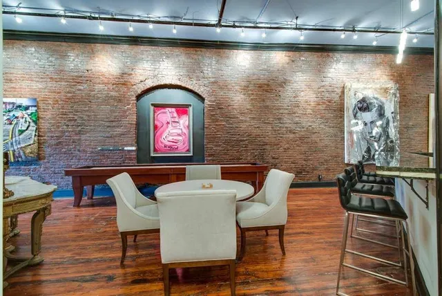a view of a dinning room with furniture and wooden floor