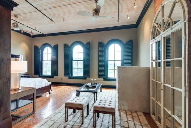 a living room with furniture a fireplace and a dining table