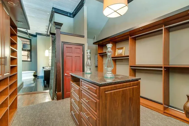 a kitchen with stainless steel appliances granite countertop a sink and cabinets