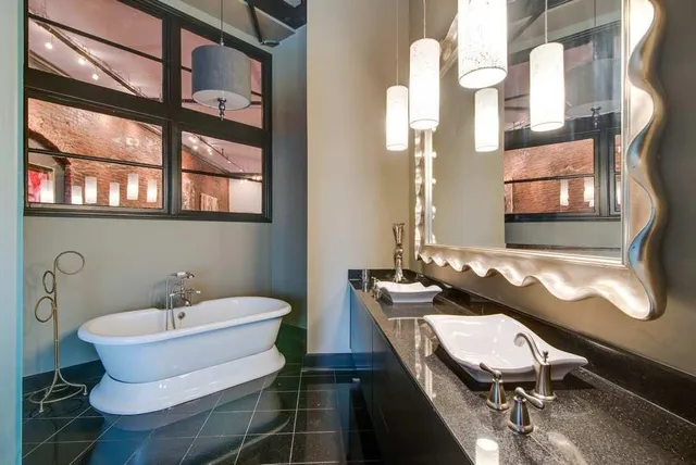 a bathroom with a sink mirror and a window