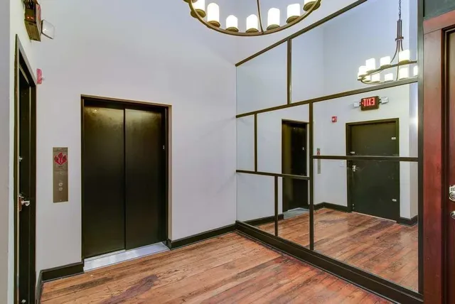a view of hallway with wooden floor