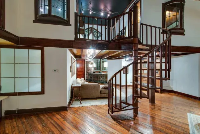 a view of entryway and hall with wooden floor