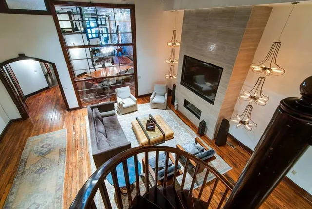 a living room with chairs and a flat screen tv