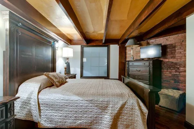 a bedroom with a bed and a television