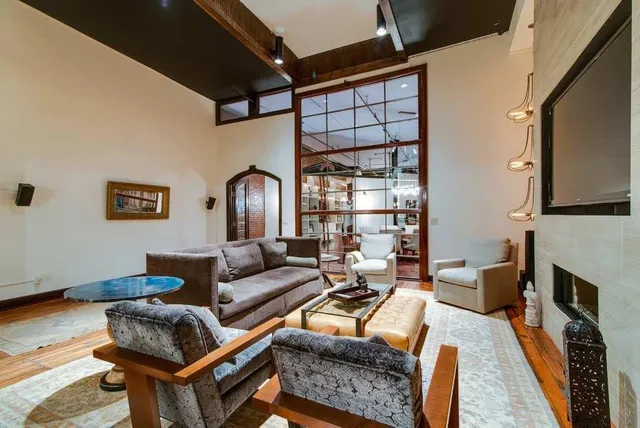 a living room with furniture a fireplace and a flat screen tv