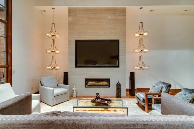 a living room with furniture a fireplace and a flat screen tv