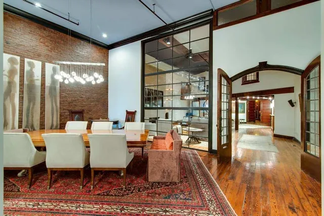 a dining room with furniture a chandelier and wooden floor