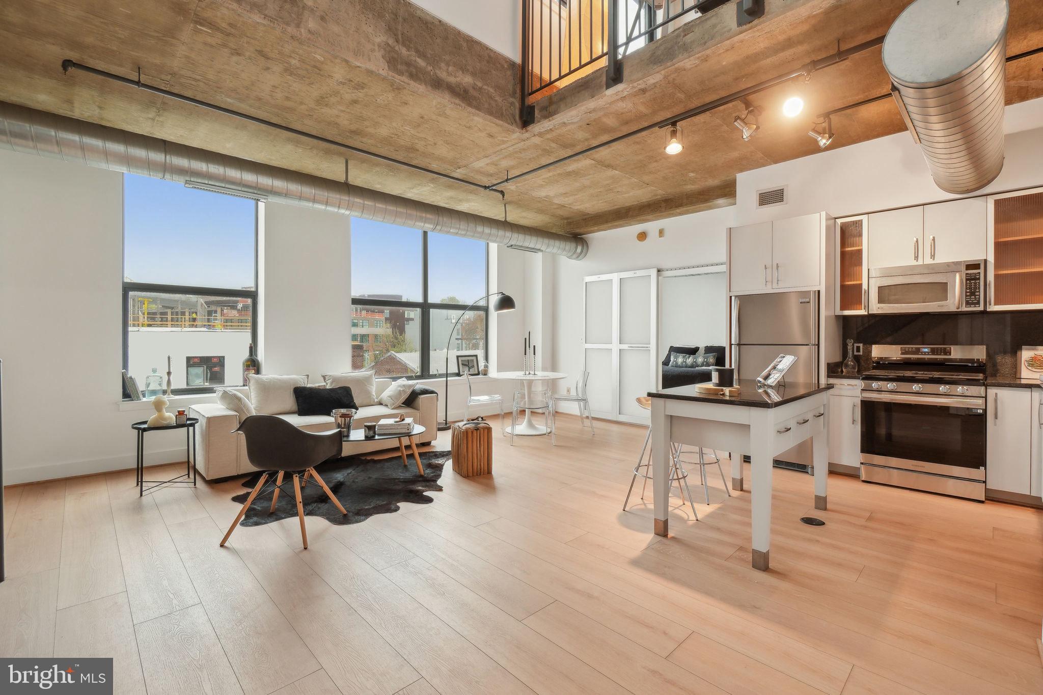 2301 Champlain Street Northwest, Unit 412 Washington, DC 20009 - Photo 1 of 20 a living room with furniture wooden floor and a fireplace