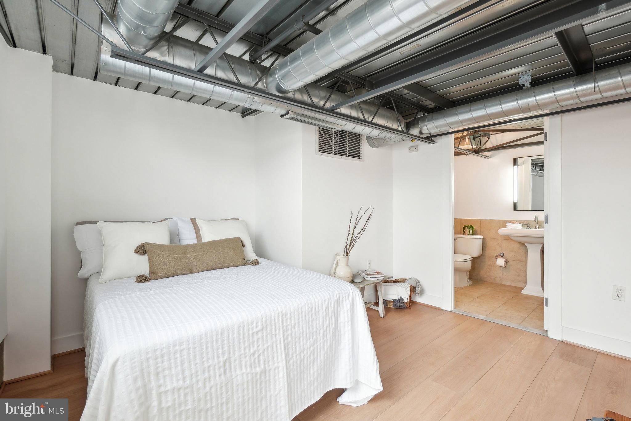 2301 Champlain Street Northwest, Unit 412 Washington, DC 20009 - Photo 12 of 20 a bedroom with a bed and a large mirror
