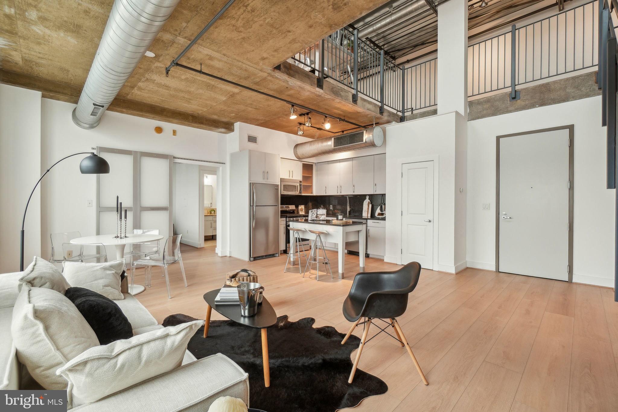 2301 Champlain Street Northwest, Unit 412 Washington, DC 20009 - Photo 6 of 20 a living room with lots of furniture and kitchen view