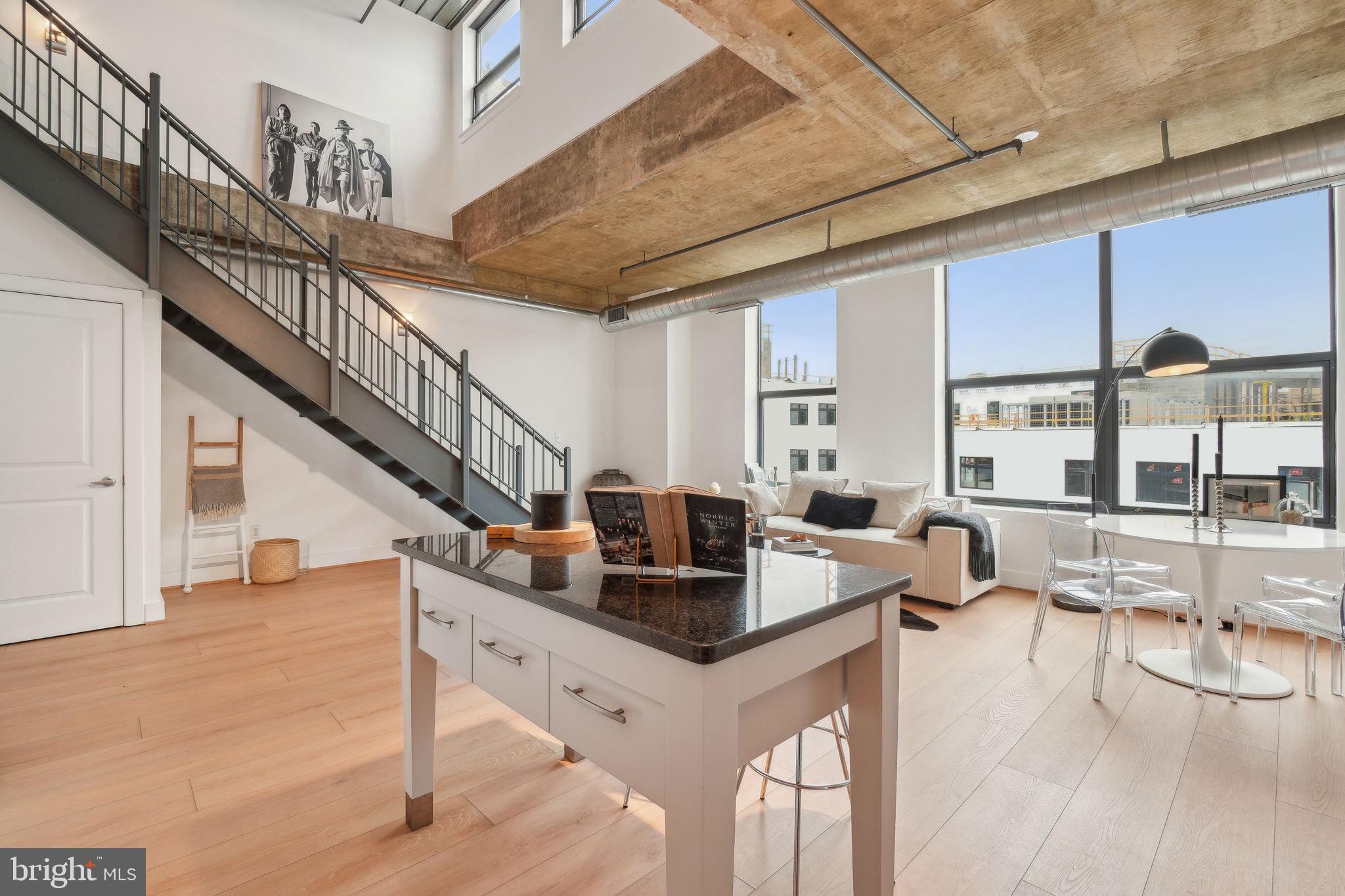 2301 Champlain Street Northwest, Unit 412 Washington, DC 20009 - Photo 10 of 20 a living room with couches a coffee table and a chandelier