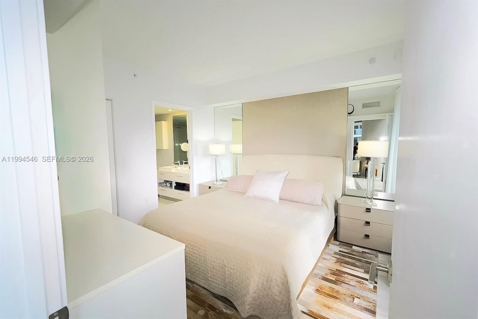 55 Southwest 9th Street, Unit 1001 Miami, FL 33130 - Photo 18 of 30 a bedroom with a bed and a cabinets