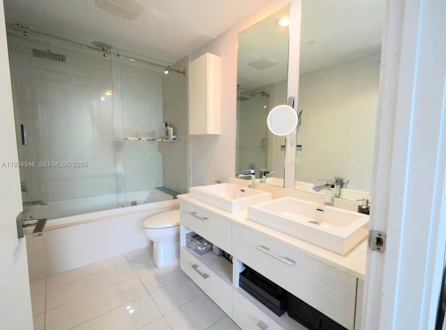 55 Southwest 9th Street, Unit 1001 Miami, FL 33130 - Photo 20 of 30 a bathroom with a sink a toilet and shower