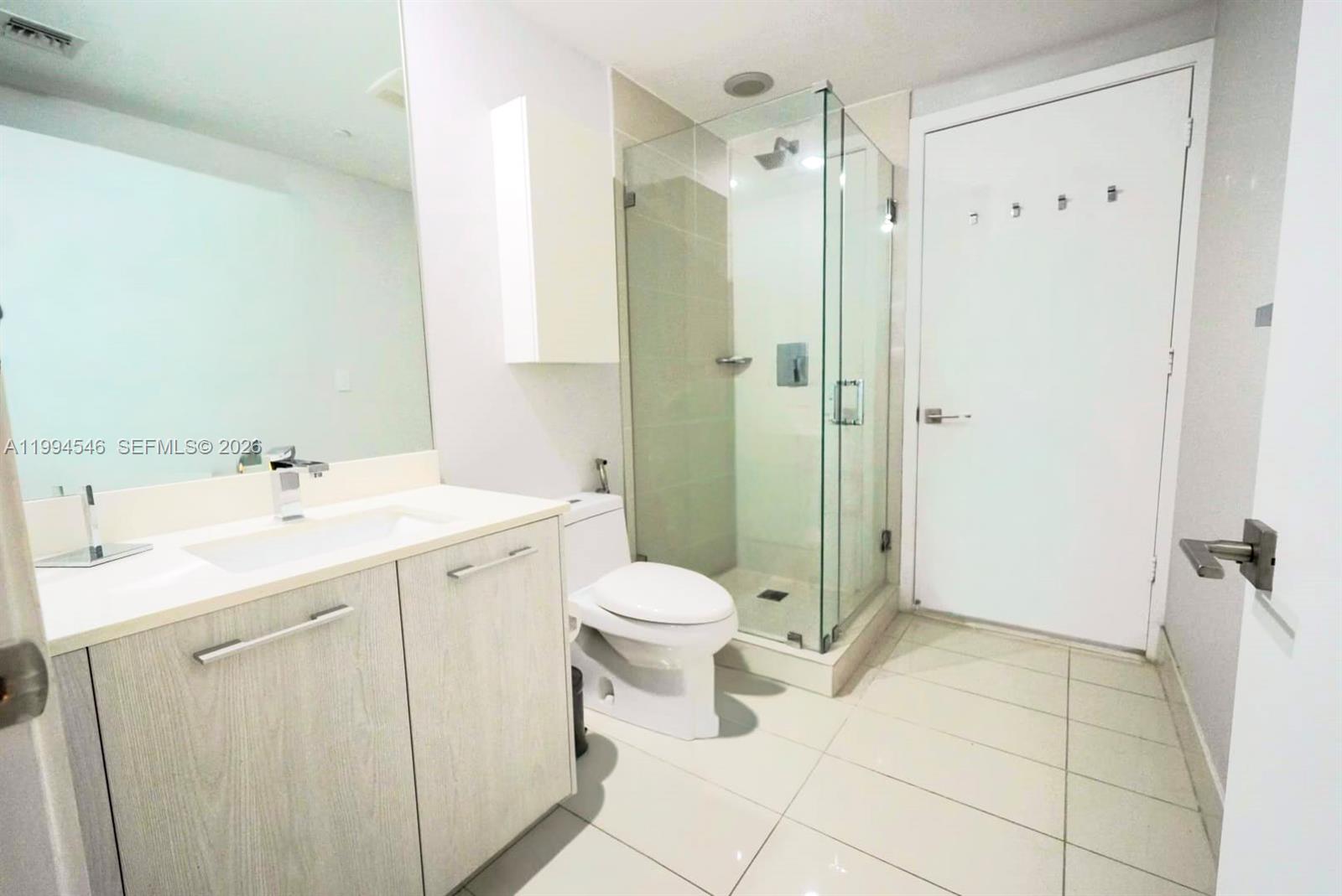 55 Southwest 9th Street, Unit 1001 Miami, FL 33130 - Photo 24 of 30 a bathroom with a sink toilet and shower