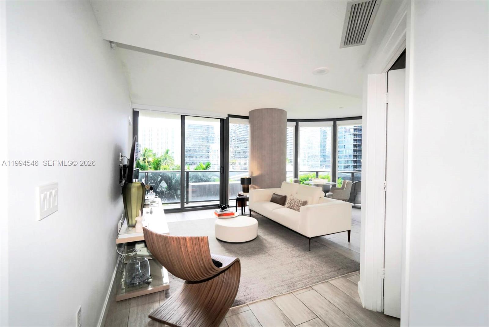 55 Southwest 9th Street, Unit 1001 Miami, FL 33130 - Photo 9 of 30 a living room with furniture and a large window