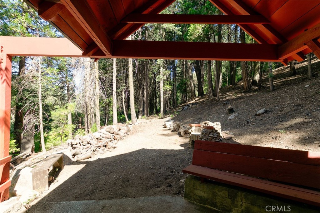 465 Blue Jay Canyon Road Blue Jay, CA 92317 - Photo 11 of 26 a view of a porch with a yard fountain and a fire pit