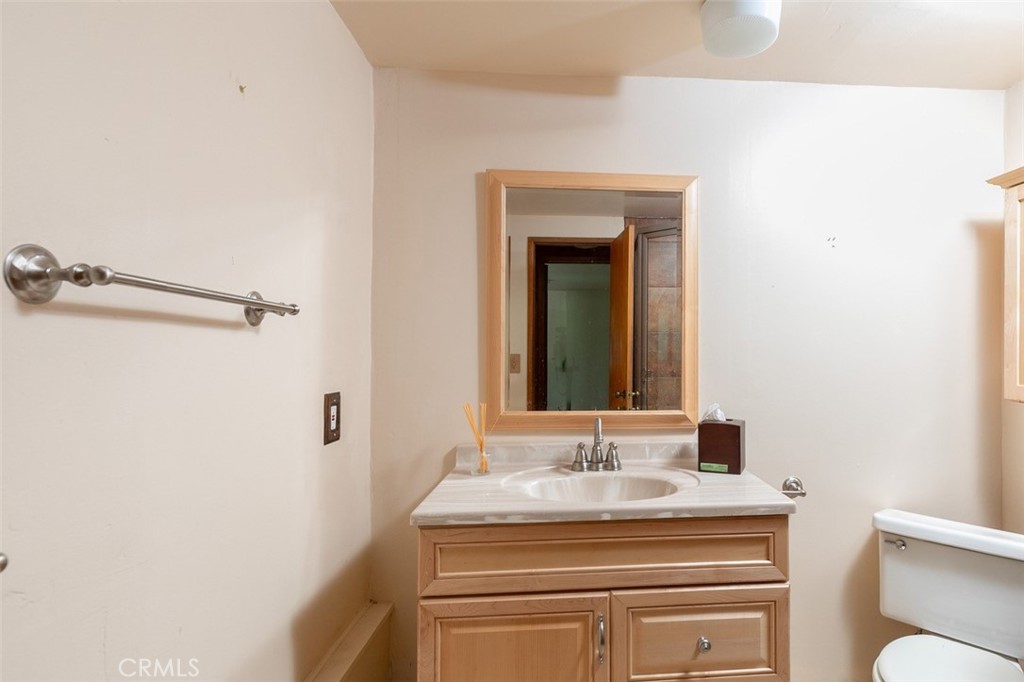 465 Blue Jay Canyon Road Blue Jay, CA 92317 - Photo 14 of 26 a bathroom with a sink and a mirror