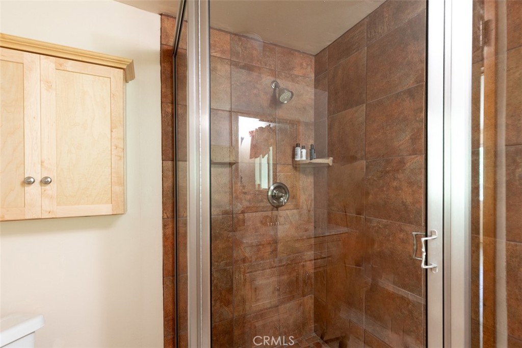 465 Blue Jay Canyon Road Blue Jay, CA 92317 - Photo 15 of 26 a bathroom with a glass shower door