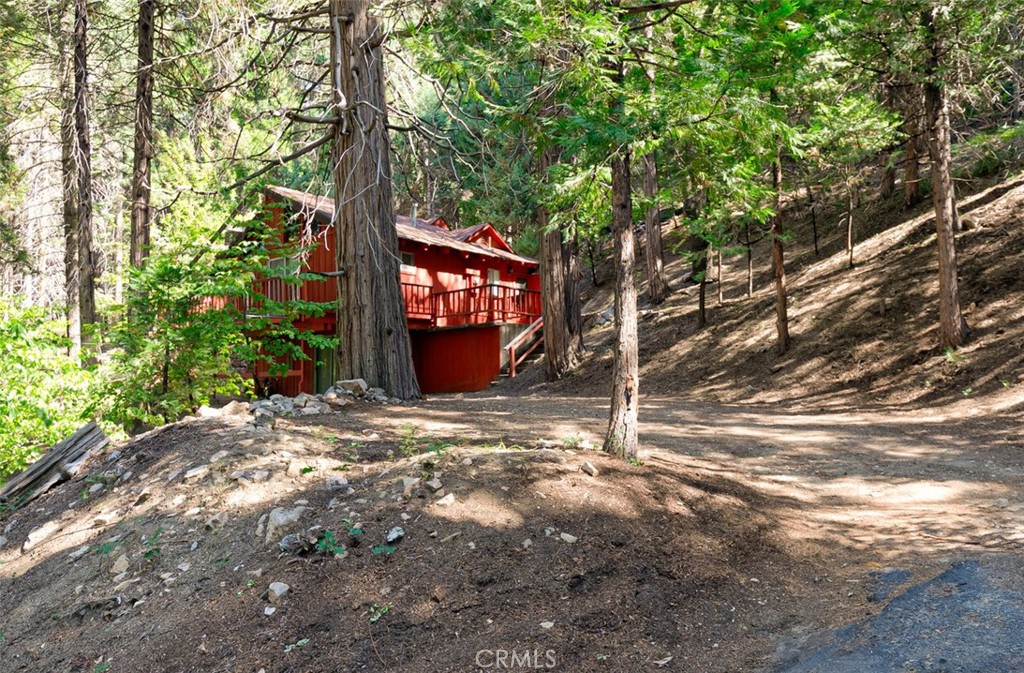 465 Blue Jay Canyon Road Blue Jay, CA 92317 - Photo 3 of 26 a sign board with tree in the background