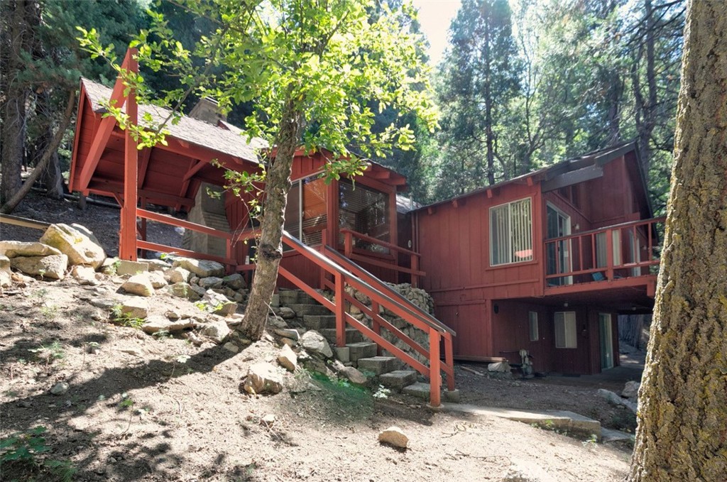 465 Blue Jay Canyon Road Blue Jay, CA 92317 - Photo 7 of 26 a small house with a tree in the background