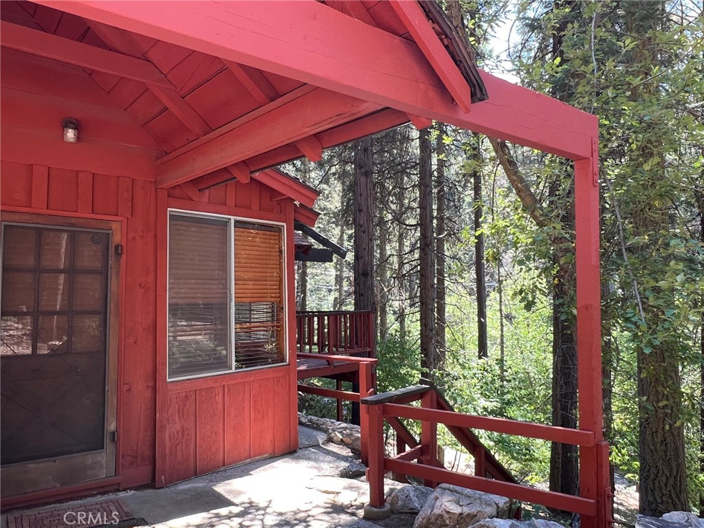 465 Blue Jay Canyon Road Blue Jay, CA 92317 - Photo 10 of 26 a view of a patio with table and chairs and wooden fence