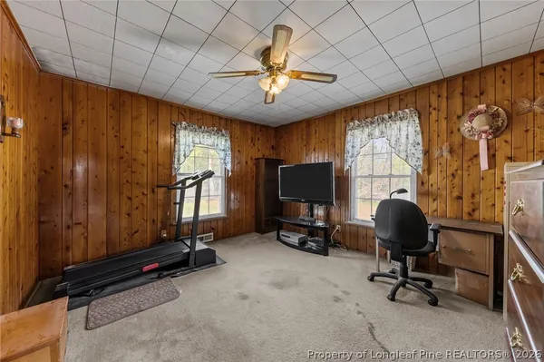 a view of a livingroom with workspace and a window