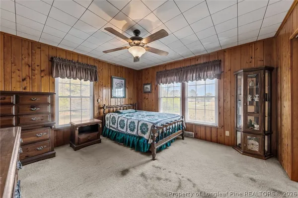 a living room with a bed furniture and a large window