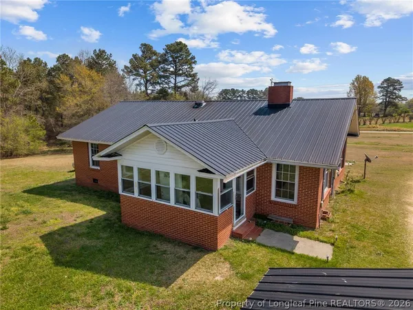 a aerial view of a house with a yard