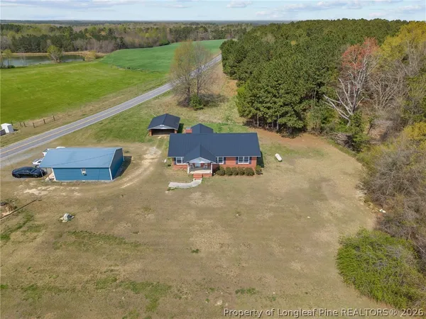 a view of a big yard with an outdoor seating