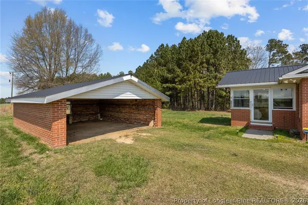 a view of a house with a yard and sitting area