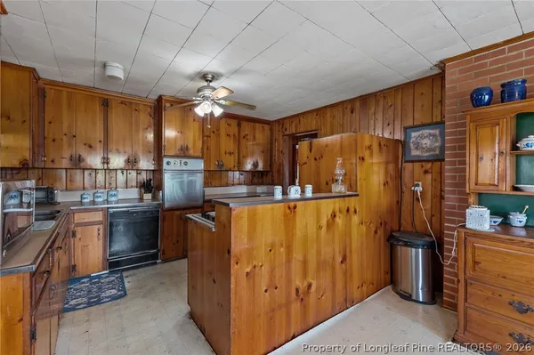 a kitchen with stainless steel appliances granite countertop a refrigerator and a stove