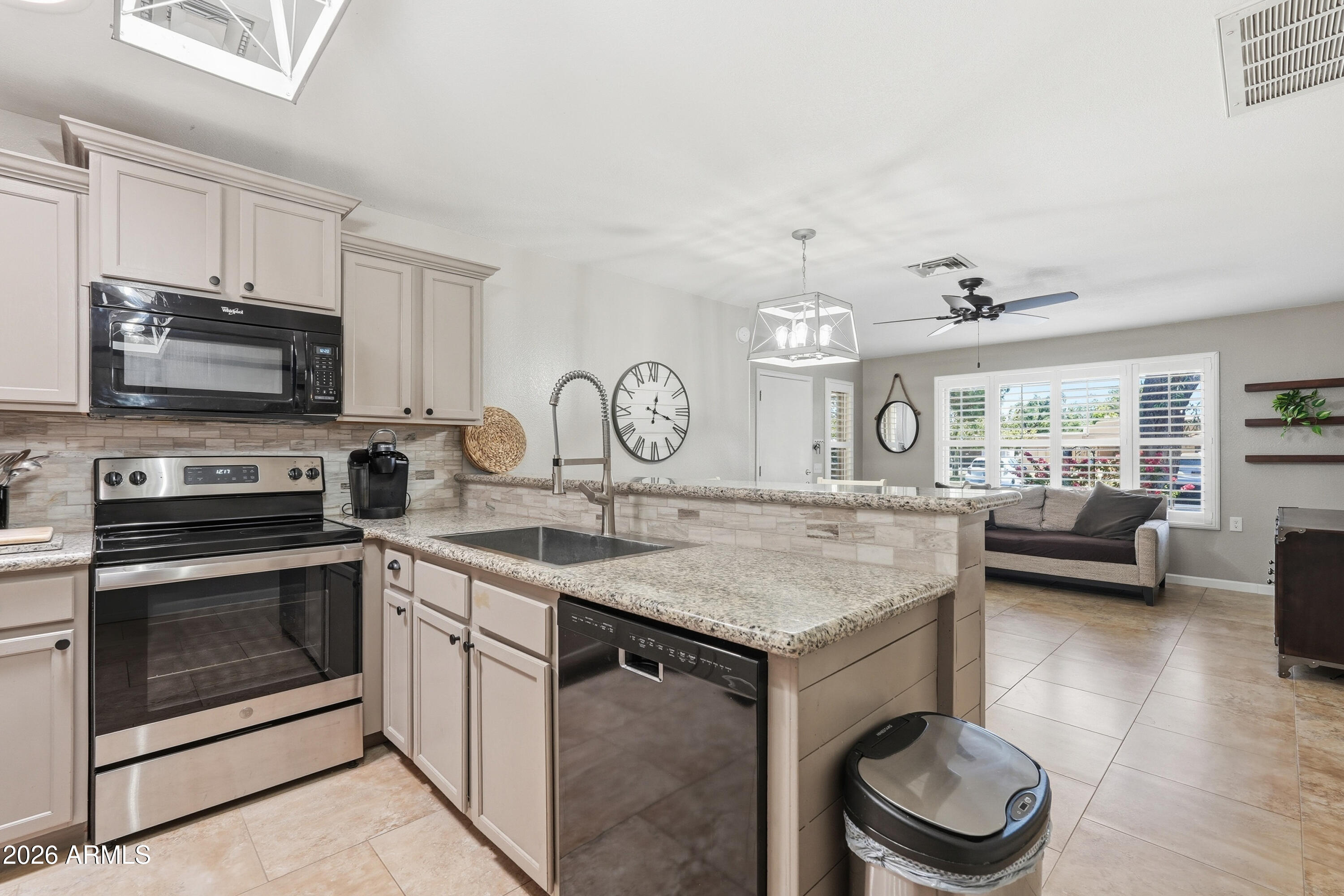 14300 West Bell Road, Unit 49 Surprise, AZ 85374 - Photo 5 of 19 a kitchen with a stove and a sink