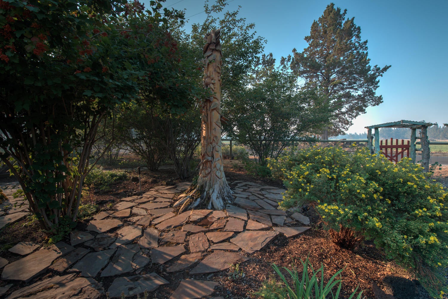 22222 Erickson Road Bend, OR 97701 - Photo 59 of 100 Custom totem pole carved by local artist from dead tree trunk in garden