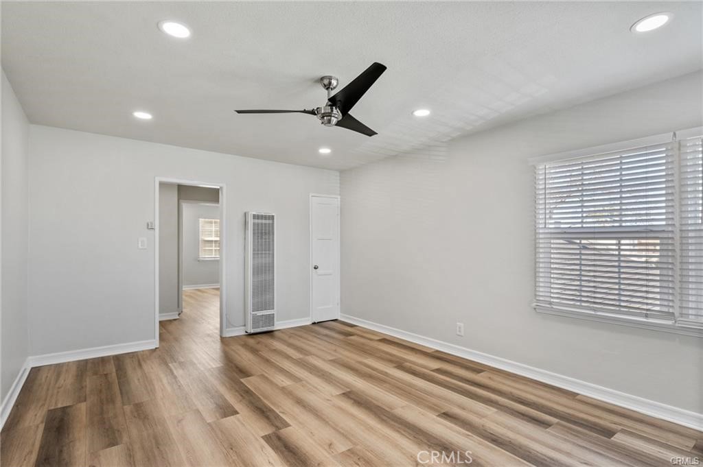 15702 Halldale Avenue Gardena, CA 90247 - Photo 17 of 25 a view of an empty room with wooden floor and a window