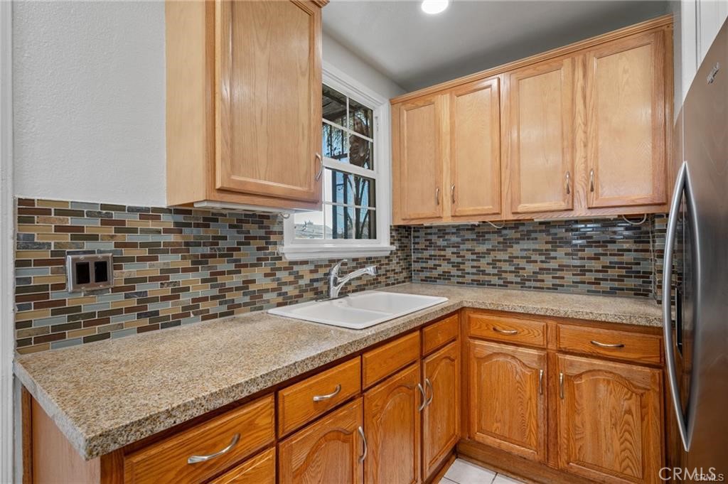 15702 Halldale Avenue Gardena, CA 90247 - Photo 9 of 25 a kitchen with granite countertop a sink and cabinets