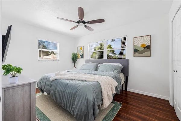 a bed sitting in a bedroom next to a window