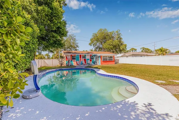 a view of a swimming pool with an outdoor seating