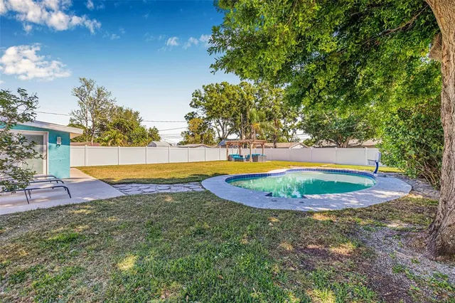 a view of a swimming pool with an outdoor space and seating area