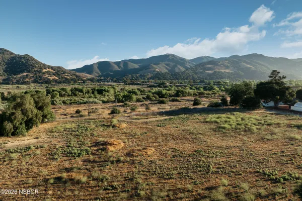 a view of a town with mountains in the background