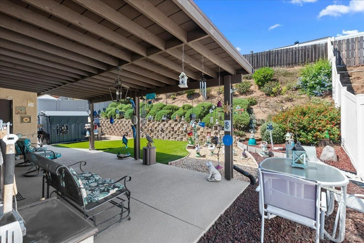 9254 Shadow Hill Road Santee, CA 92071 - Photo 28 of 34 a view of a patio with table and chairs potted plants with wooden floor and fence
