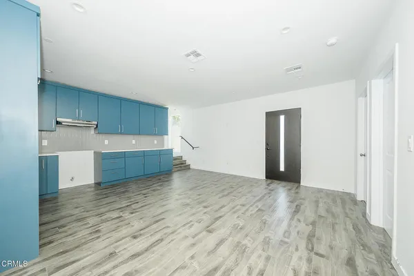 a view of a kitchen with wooden floor