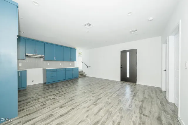 a view of a kitchen with wooden floor