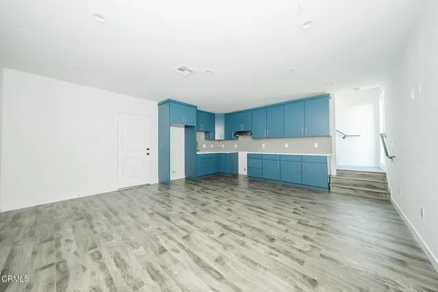 a view of a kitchen with a sink and cabinets