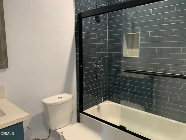 a bathroom with a toilet and bathtub