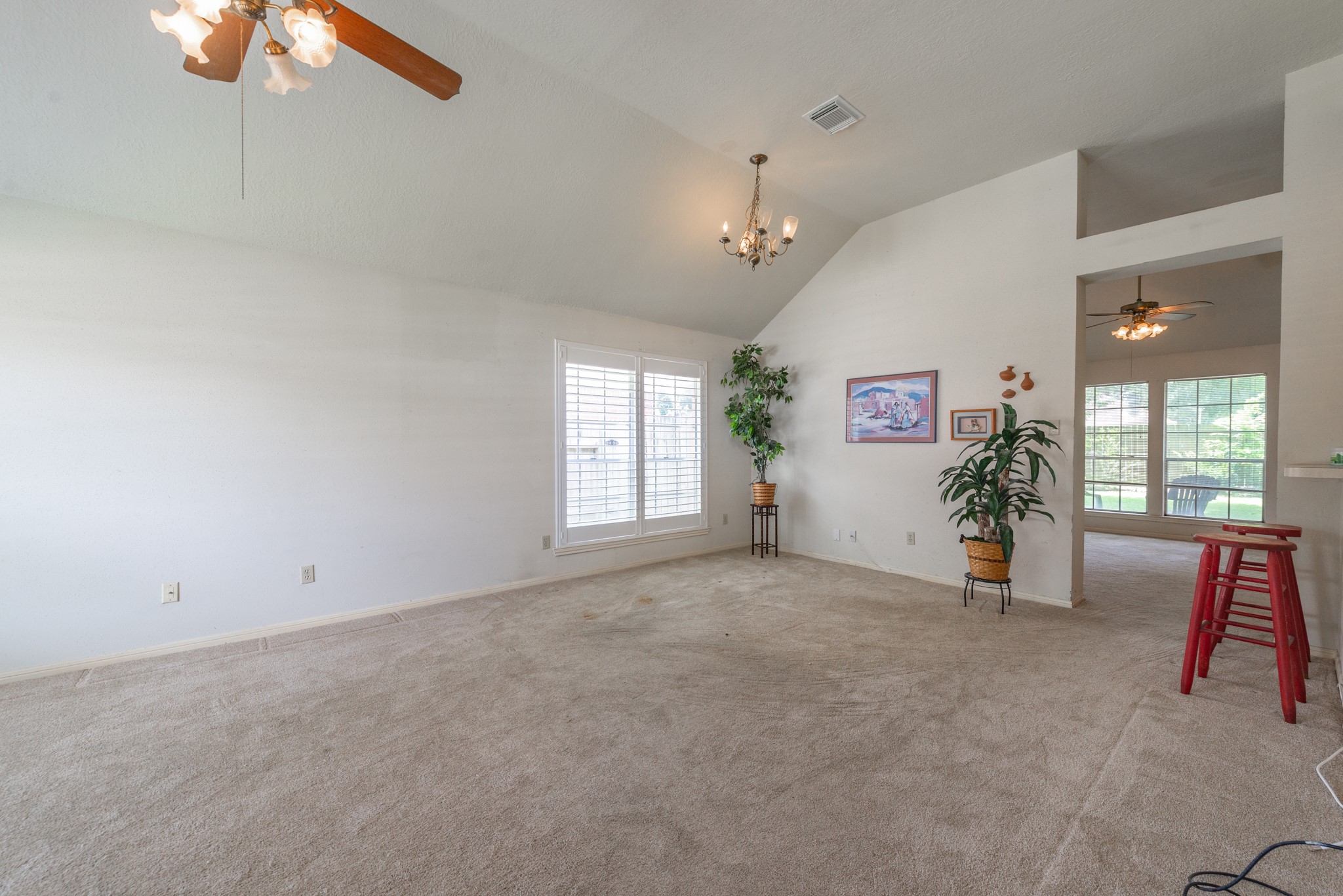 12203 Canterhurst Way Houston, TX 77065 - Photo 3 of 23 an empty room with windows and ceiling fan