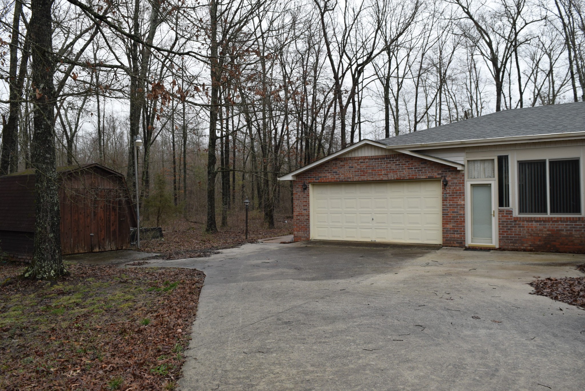 121 Asbury Road Manchester, TN 37355 - Photo 12 of 13 a front view of a house with a yard and garage
