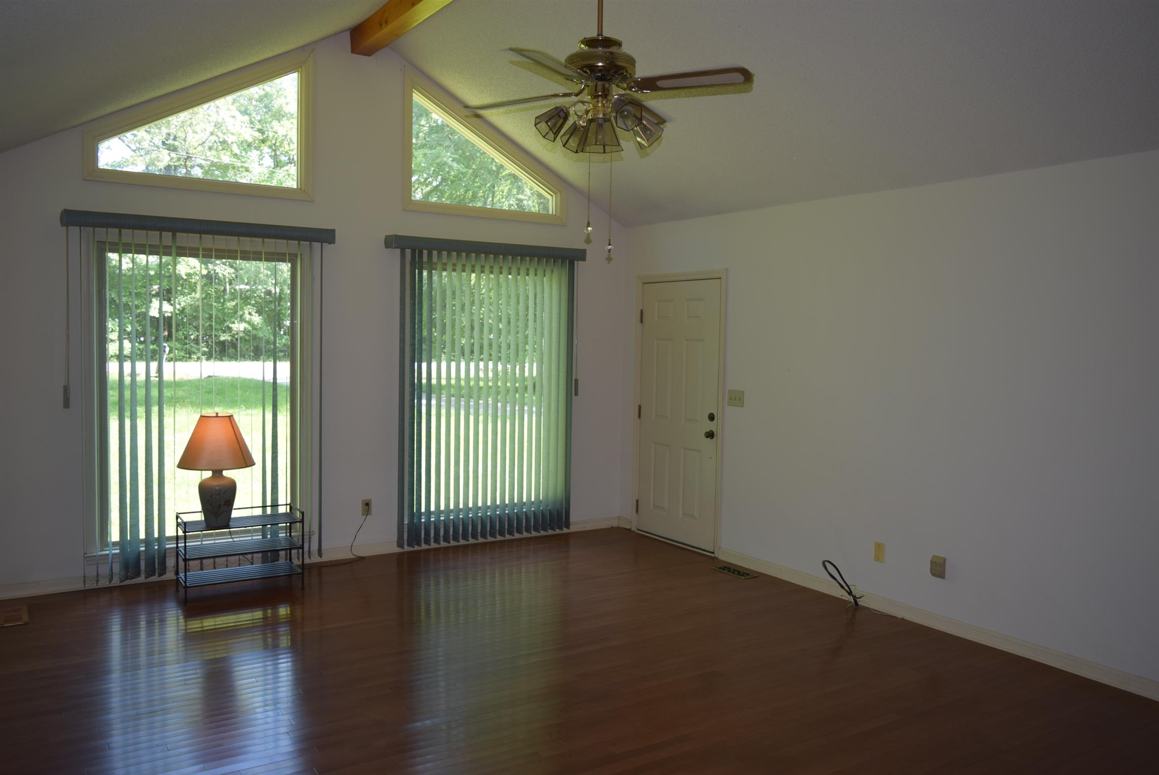 121 Asbury Road Manchester, TN 37355 - Photo 2 of 13 a view of empty room with wooden floor and fan